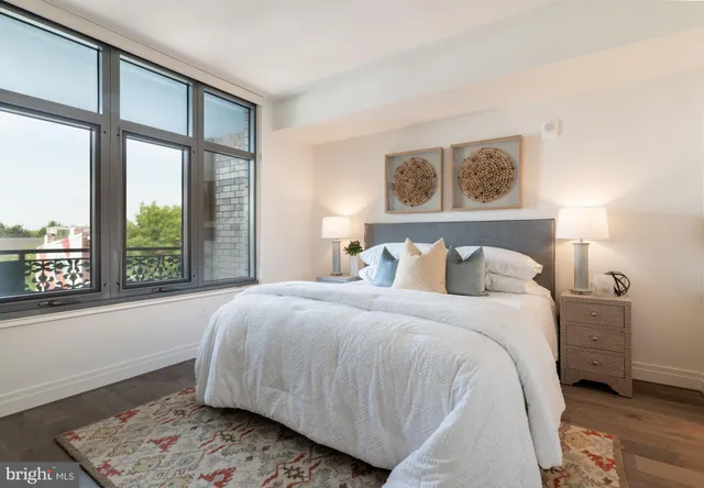 a bedroom with a large bed and a window