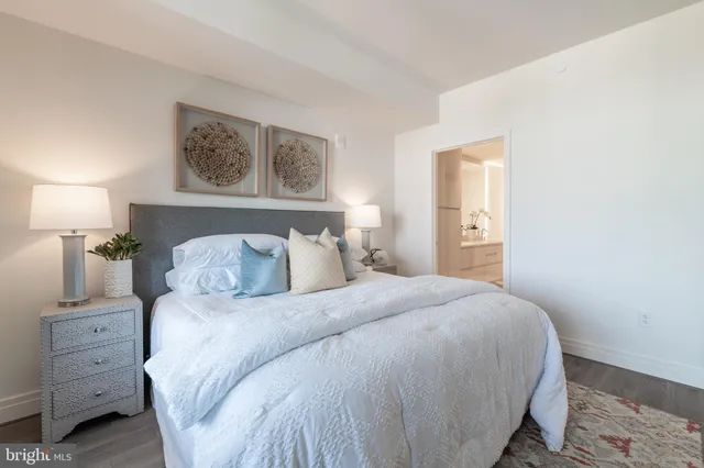 a bedroom with a bed and a night stand