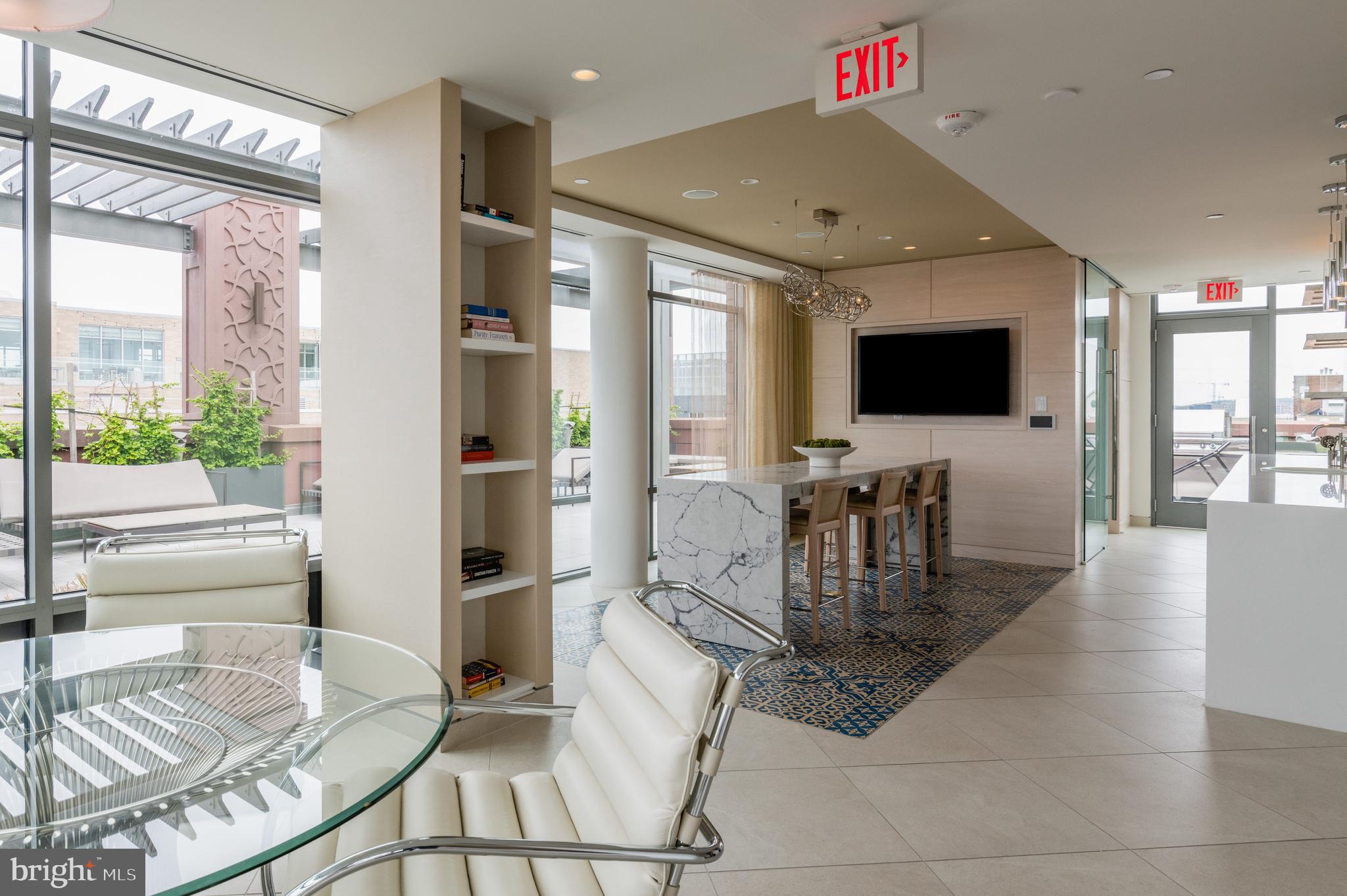 810 O Street Northwest, Unit 706 Washington, DC 20001 - Photo 45 of 48 a work room with furniture a flat screen tv and a large window