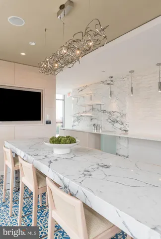 a view of a kitchen with a sink and chandelier