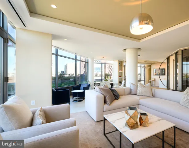 a living room with furniture and a chandelier