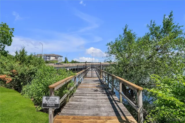a view of a balcony with wooden fence and floor