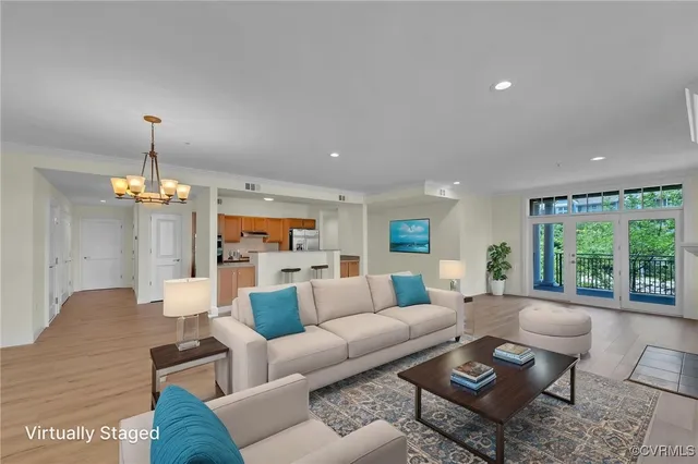 a living room with furniture and a chandelier
