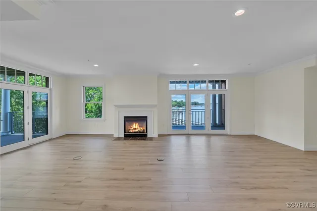 wooden floor in an empty room with a fireplace