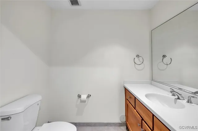 a bathroom with a sink toilet and vanity