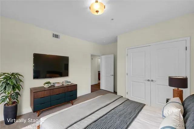 a bedroom with furniture and a flat screen tv