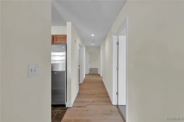 a view of a hallway with wooden floor
