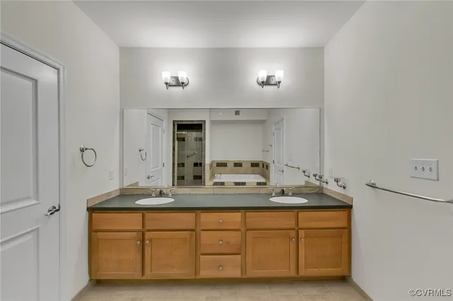 a bathroom with a sink double vanity and mirror