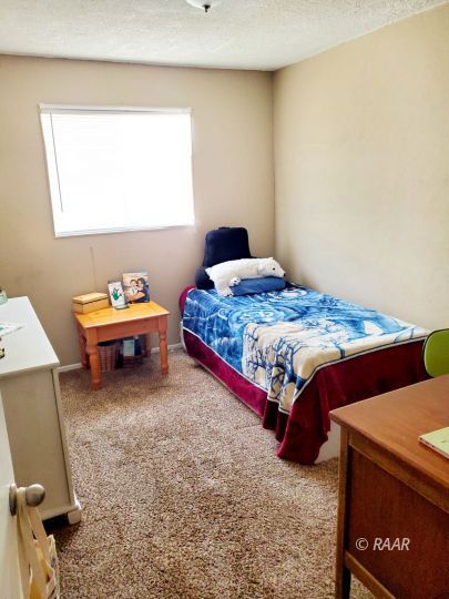 224 West Perdew Avenue Ridgecrest, CA 93555 - Photo 12 of 17 a bedroom with a bed and a dresser in it