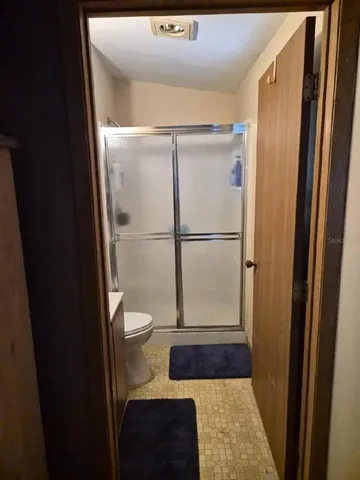 a bathroom with a sink and a glass door shower