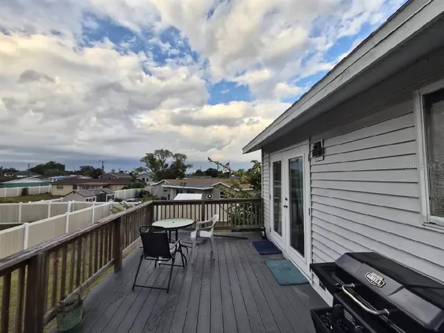 a view of a balcony with wooden floor