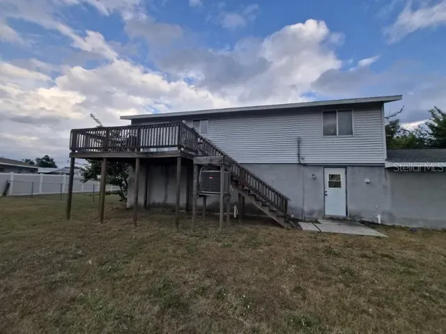 a view of a house with a wooden fence