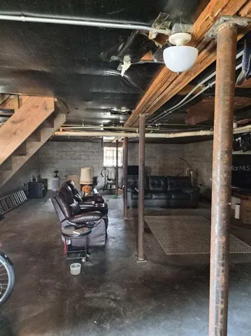 a view of a room with wooden floor