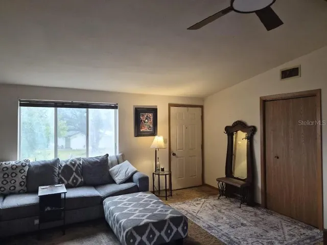 a living room with furniture and a large window