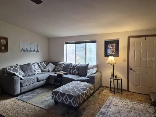 a living room with furniture and a window