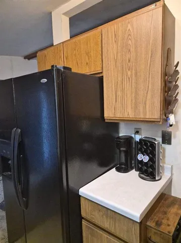 a kitchen with a refrigerator and a stove