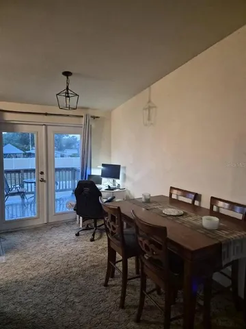 a view of a dining room with furniture and chandelier