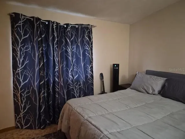 a bedroom with a bed and a closet