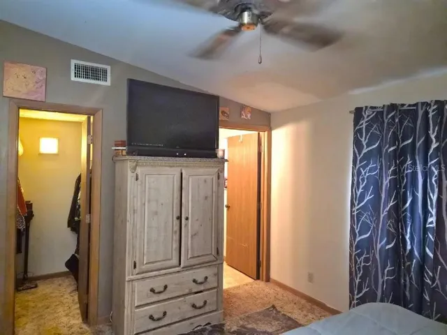 a view of a livingroom with furniture and a flat screen tv