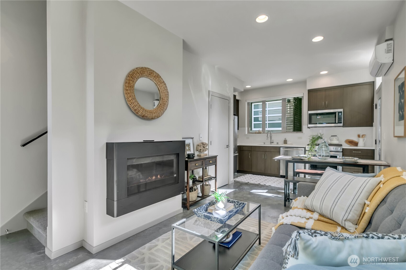5008 Fauntleroy Way Southwest, Unit B Seattle, WA 98136 - Photo 11 of 36 a living room with furniture a fireplace and a flat screen tv