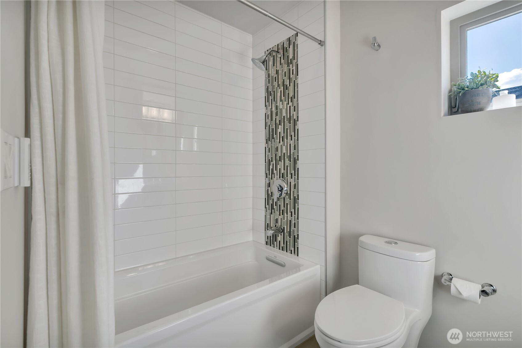 5008 Fauntleroy Way Southwest, Unit B Seattle, WA 98136 - Photo 20 of 36 a white toilet sitting next to a bath tub