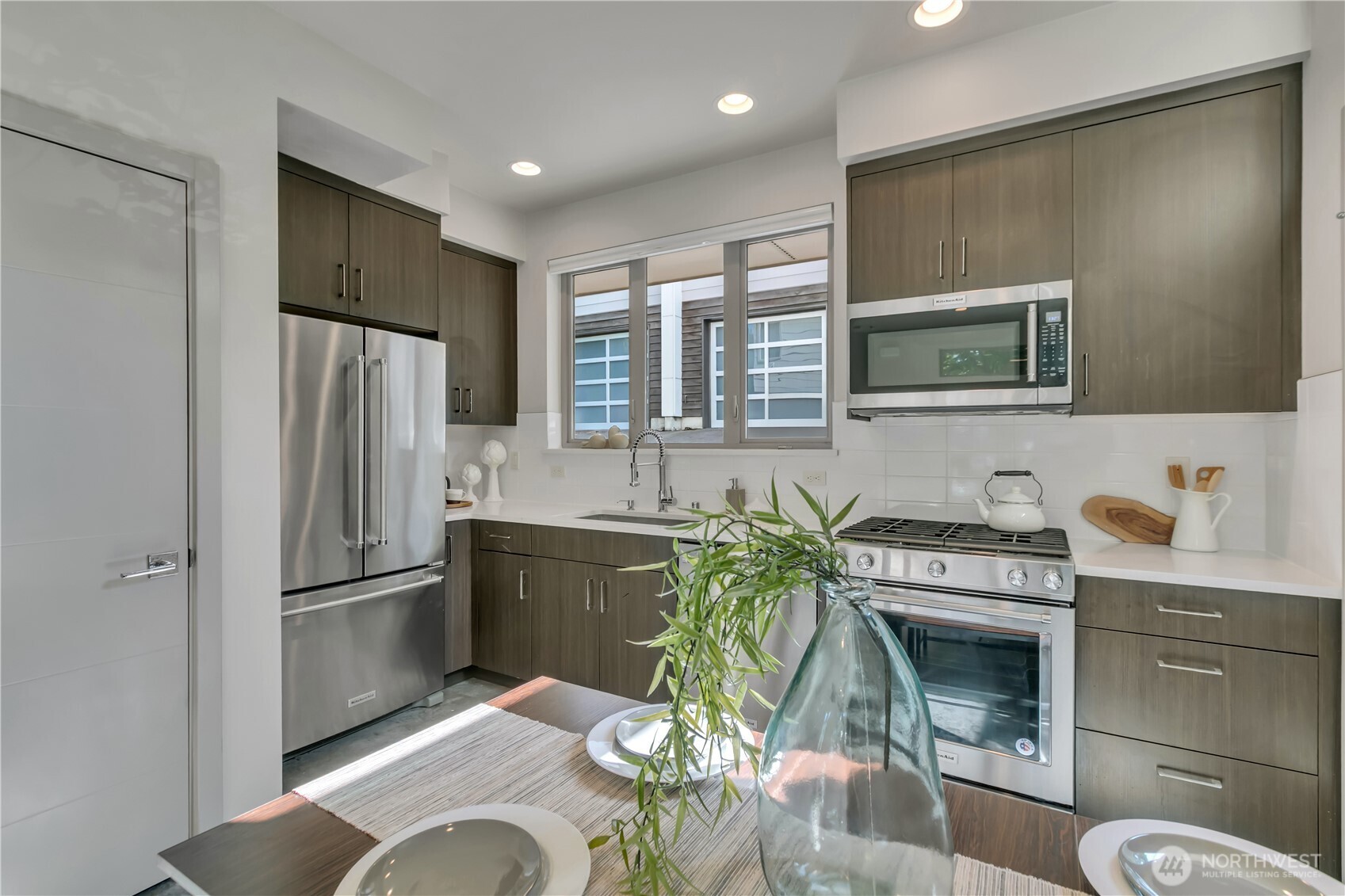 5008 Fauntleroy Way Southwest, Unit B Seattle, WA 98136 - Photo 3 of 36 a kitchen with stainless steel appliances granite countertop a refrigerator and a sink