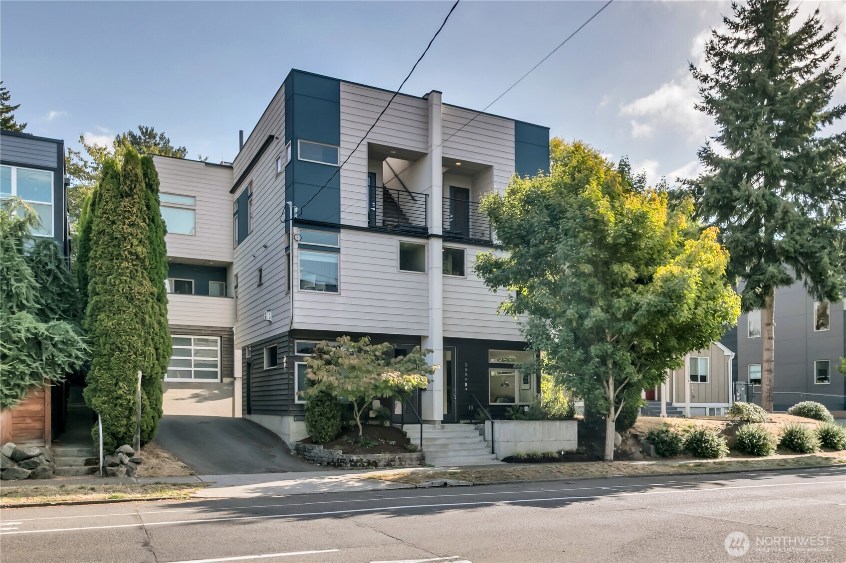 5008 Fauntleroy Way Southwest, Unit B Seattle, WA 98136 - Photo 31 of 36 a front view of a house with garage and parking
