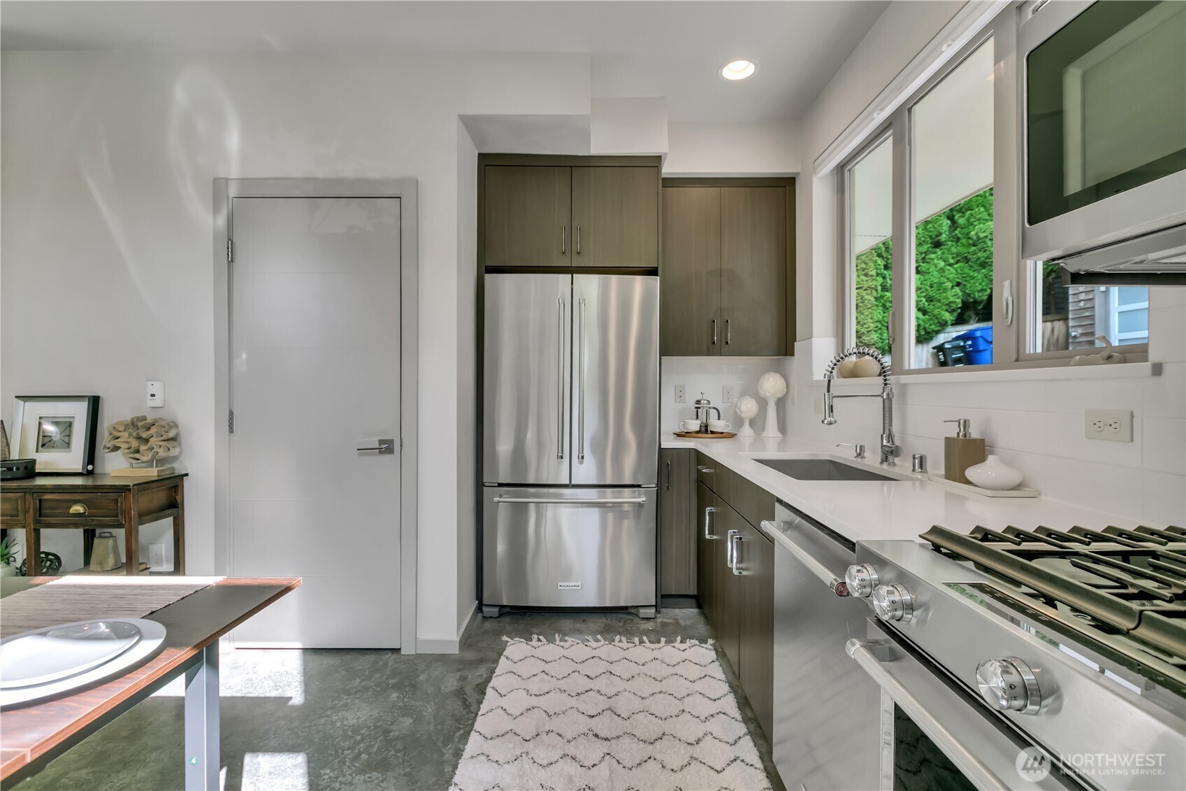 5008 Fauntleroy Way Southwest, Unit B Seattle, WA 98136 - Photo 6 of 36 a kitchen with stainless steel appliances granite countertop a sink stove and refrigerator