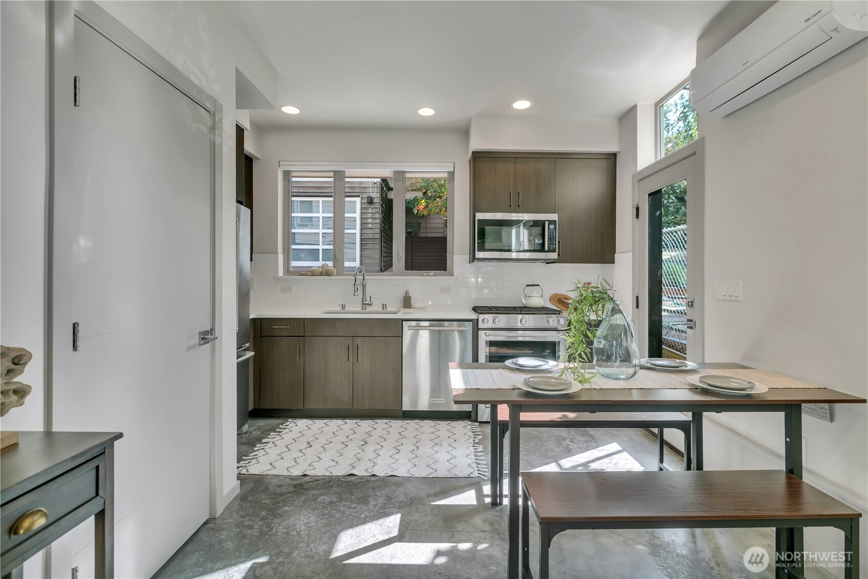 5008 Fauntleroy Way Southwest, Unit B Seattle, WA 98136 - Photo 8 of 36 a living room with furniture and a potted plant