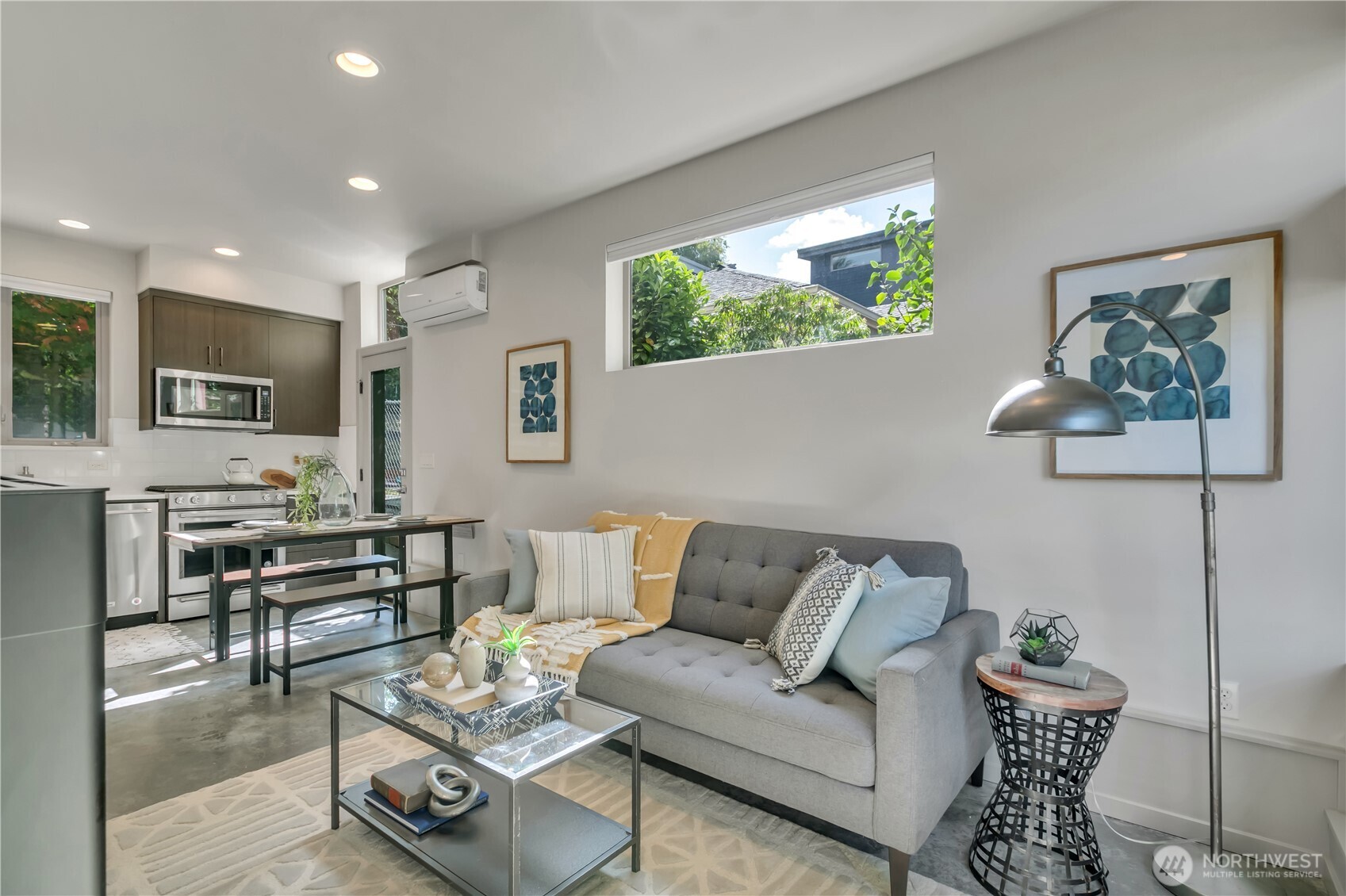 5008 Fauntleroy Way Southwest, Unit B Seattle, WA 98136 - Photo 10 of 36 a living room with furniture and a large window