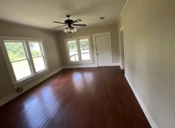 wooden floor in an empty room with a window