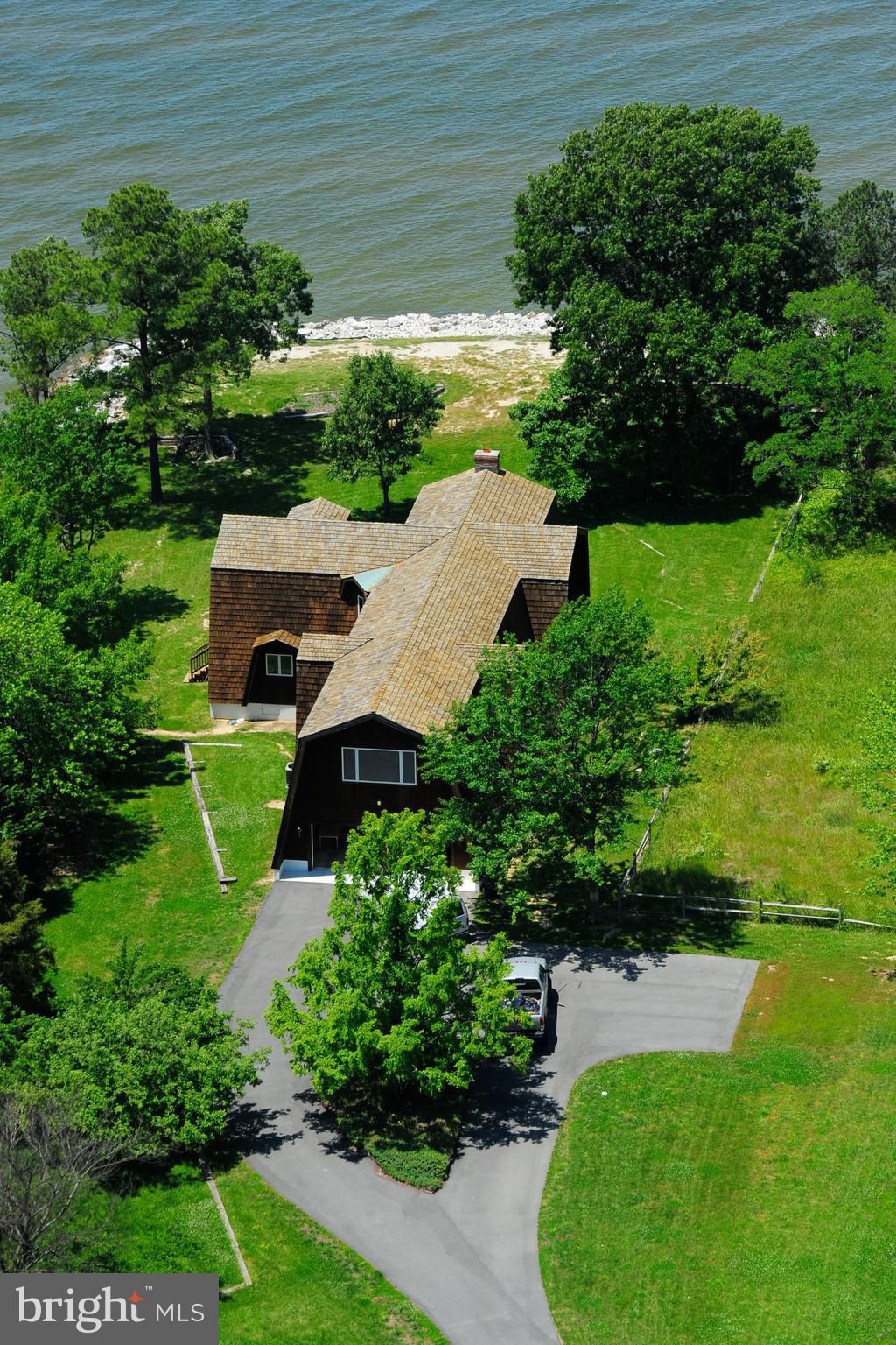 an aerial view of a house with pool patio and outdoor seating