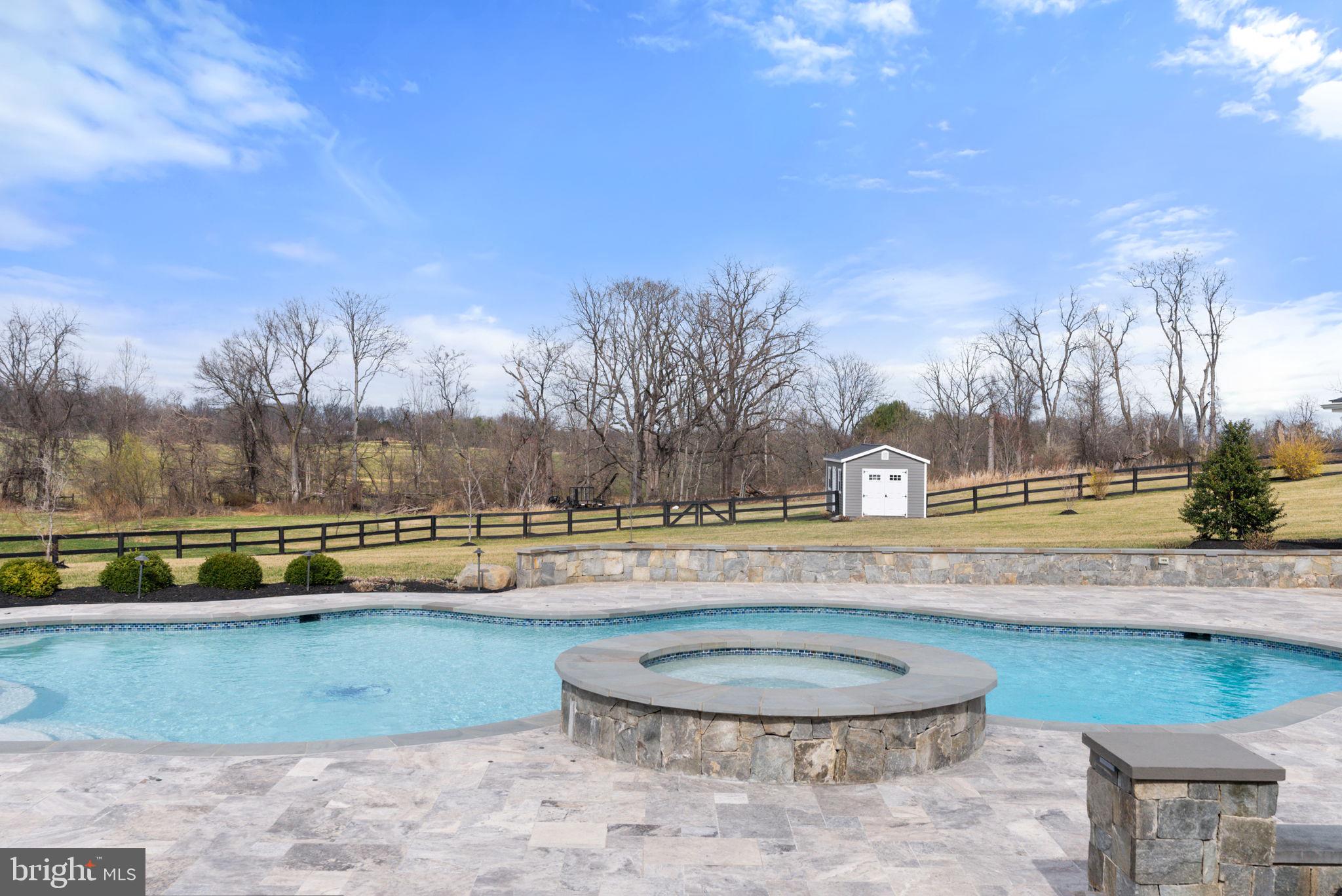 18482 Wild Raspberry Drive Purcellville, VA 20132 - Photo 104 of 143 a view of a swimming pool with an outdoor seating