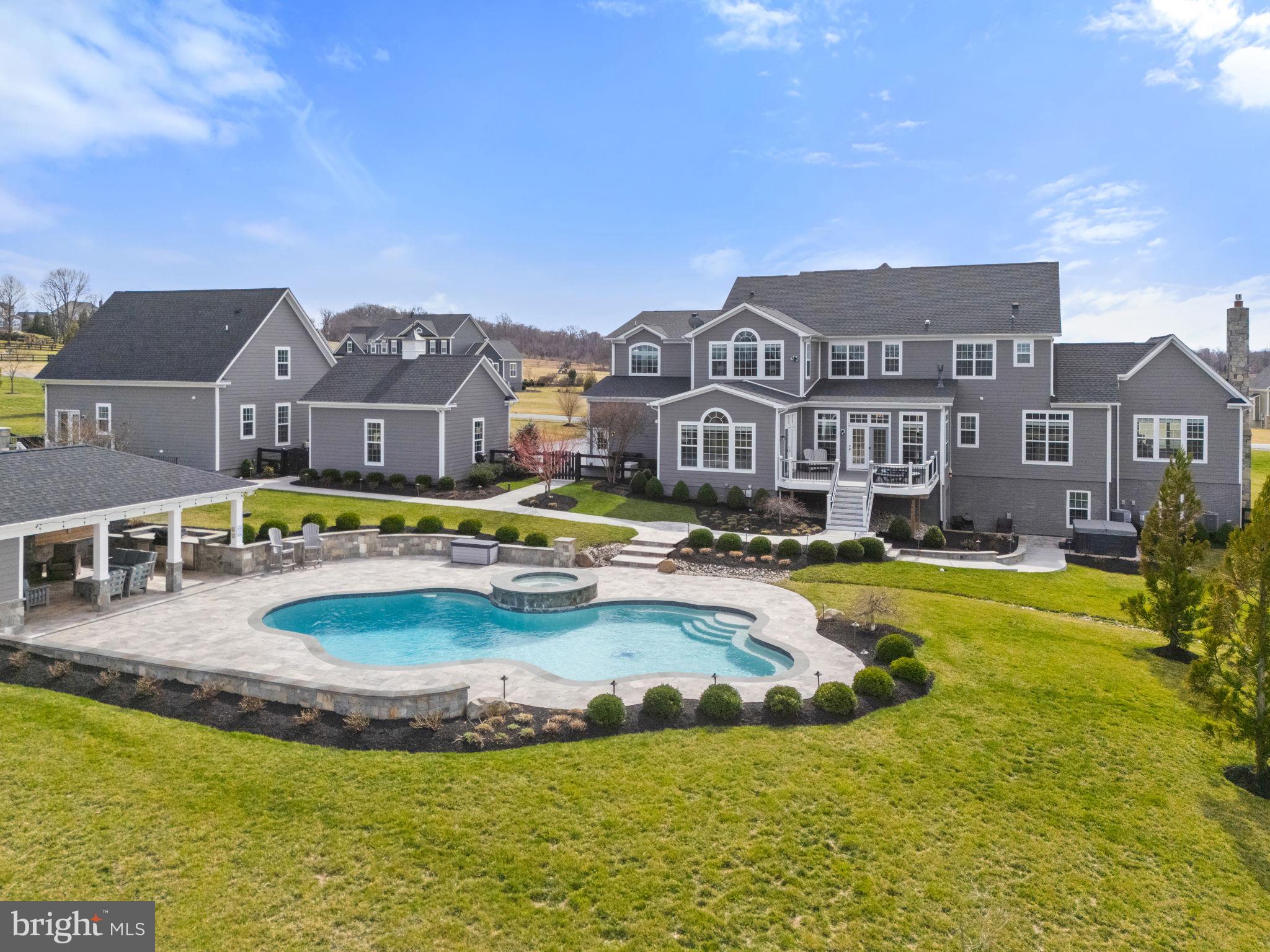 18482 Wild Raspberry Drive Purcellville, VA 20132 - Photo 138 of 143 a view of a swimming pool with a garden and plants