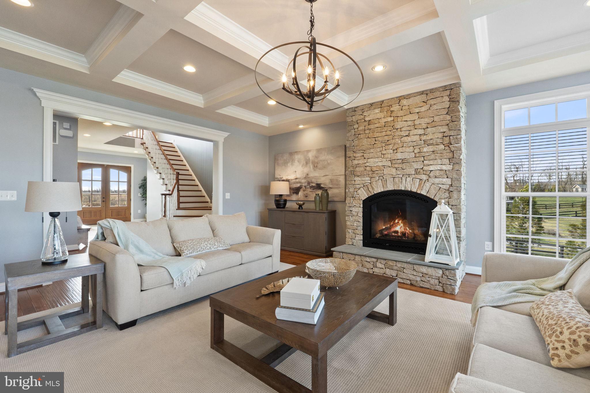 18482 Wild Raspberry Drive Purcellville, VA 20132 - Photo 40 of 143 a living room with furniture a fireplace and a large window