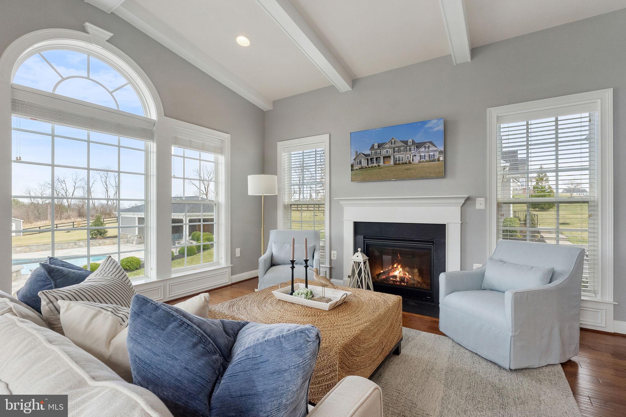 18482 Wild Raspberry Drive Purcellville, VA 20132 - Photo 55 of 143 a living room with furniture a fireplace and a large window