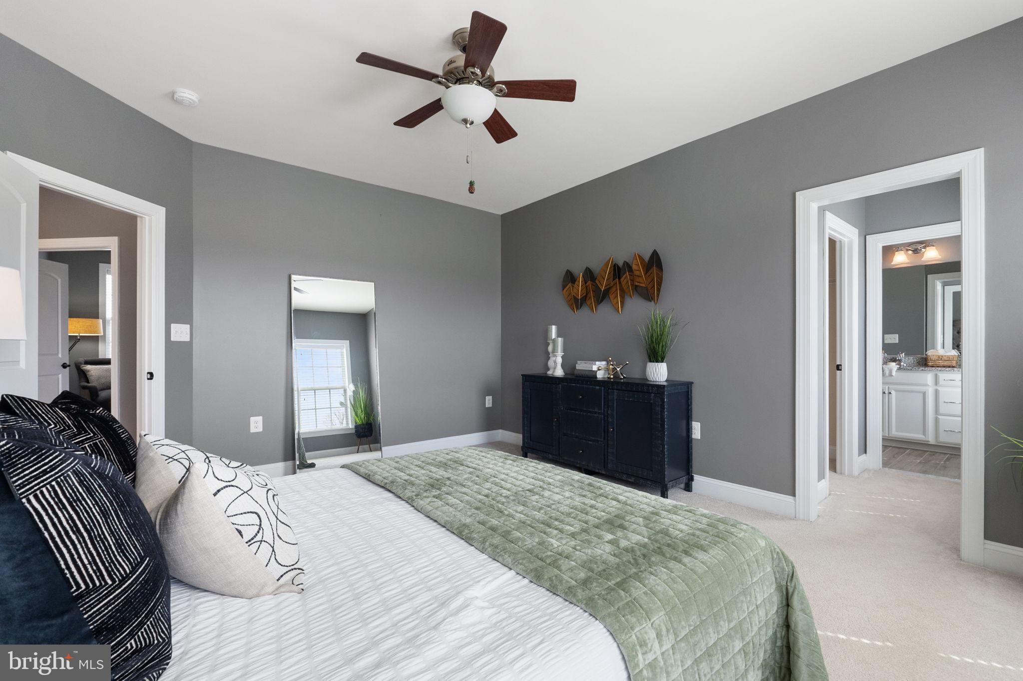 18482 Wild Raspberry Drive Purcellville, VA 20132 - Photo 77 of 143 a bedroom with a bed and a chandelier