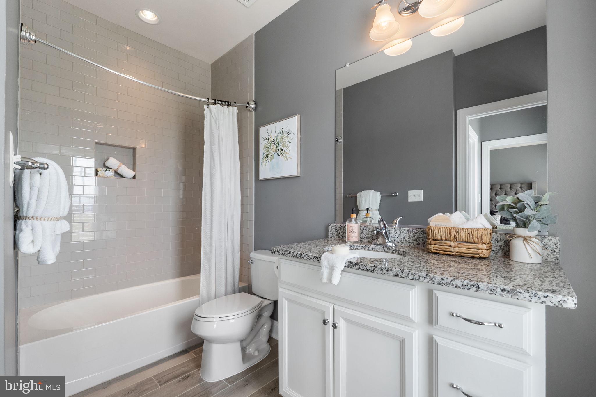 18482 Wild Raspberry Drive Purcellville, VA 20132 - Photo 79 of 143 a bathroom with a granite countertop sink toilet and shower