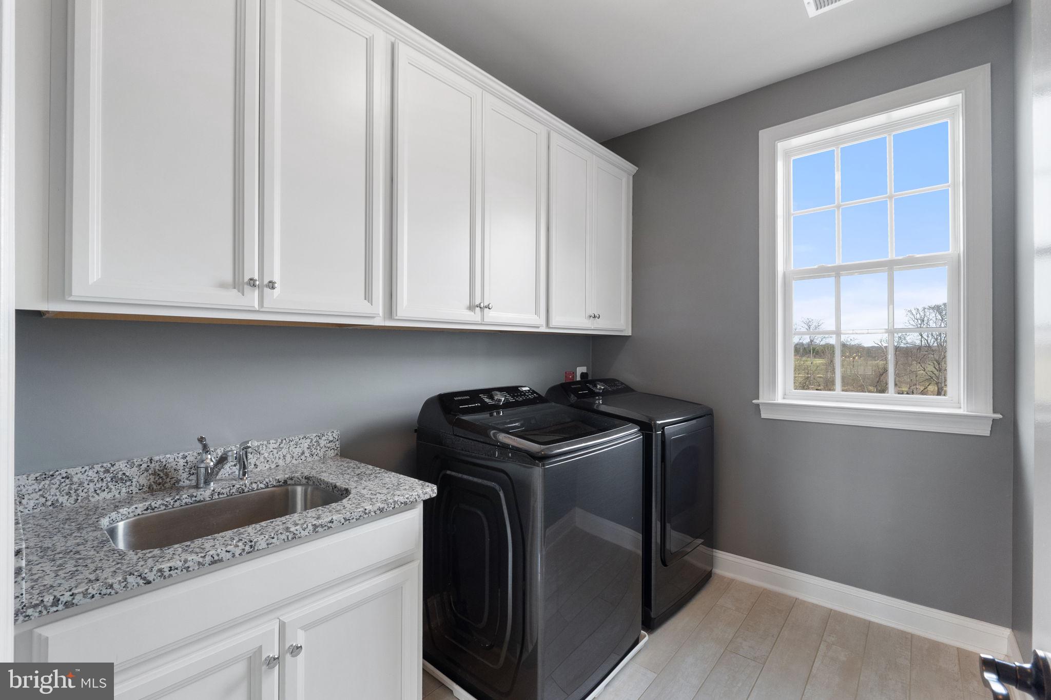 18482 Wild Raspberry Drive Purcellville, VA 20132 - Photo 89 of 143 a kitchen with granite countertop a stove sink and cabinets