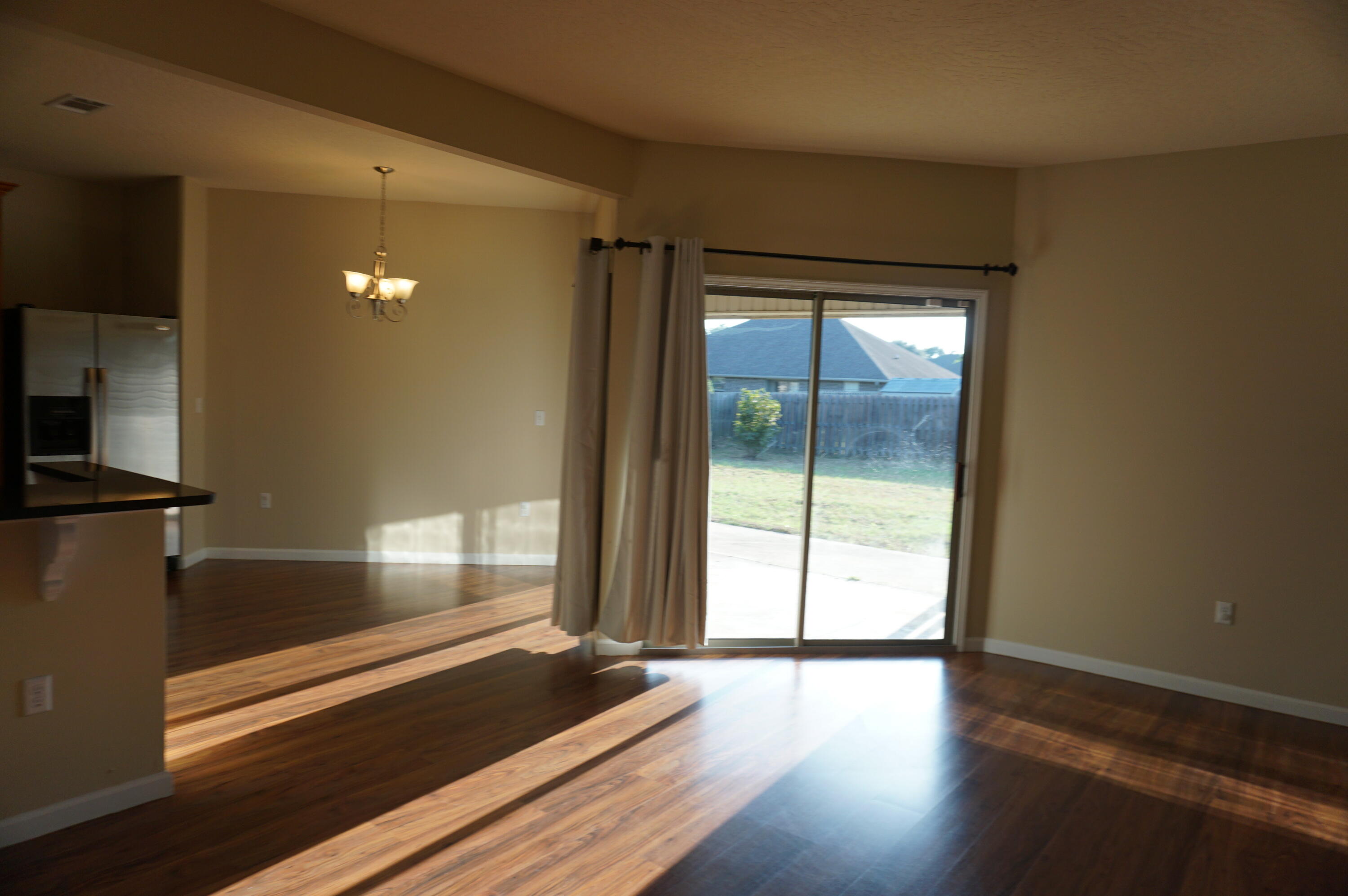 5263 Moore Loop Crestview, FL 32536 - Photo 13 of 37 a view of a room with wooden floor and windows