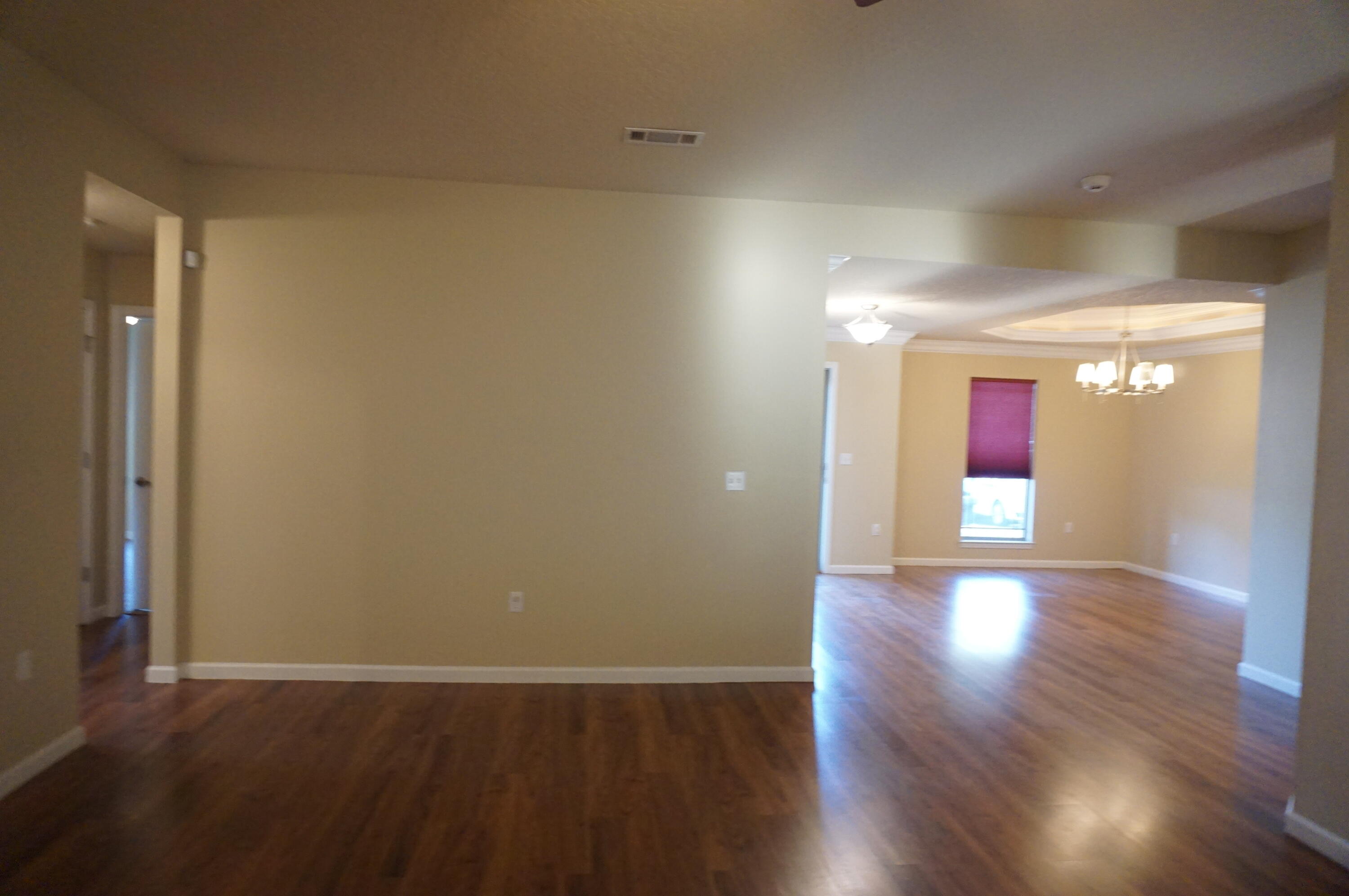 5263 Moore Loop Crestview, FL 32536 - Photo 15 of 37 an empty room with wooden floor and windows