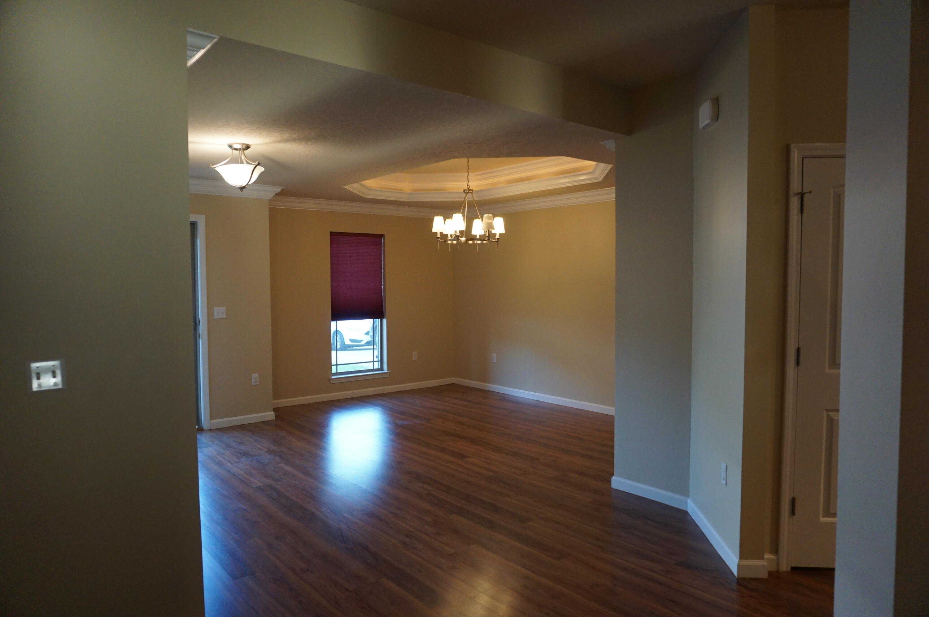 5263 Moore Loop Crestview, FL 32536 - Photo 16 of 37 a view of wooden floor and windows in a room