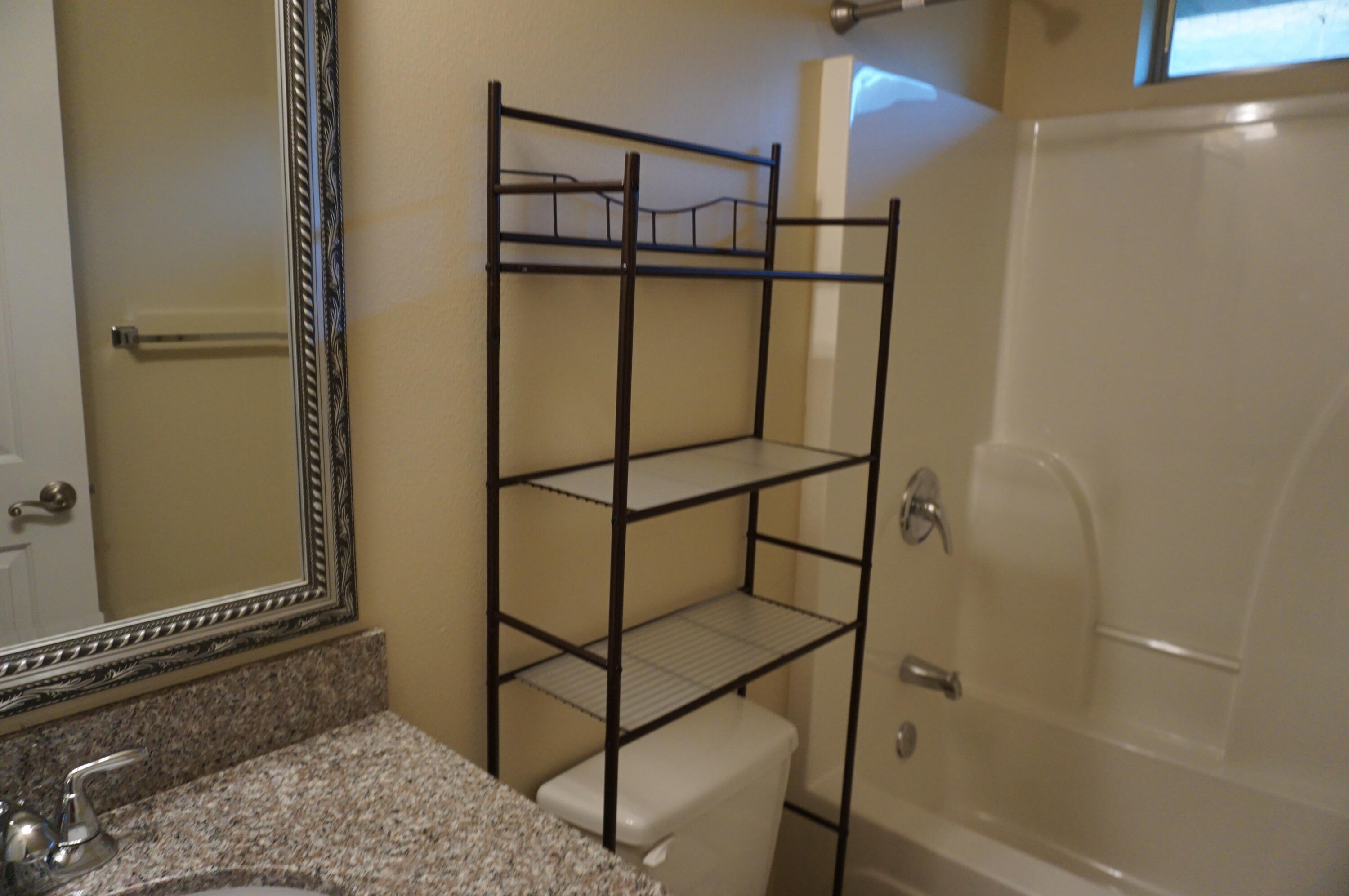 5263 Moore Loop Crestview, FL 32536 - Photo 21 of 37 a bathroom with a shower and a mirror