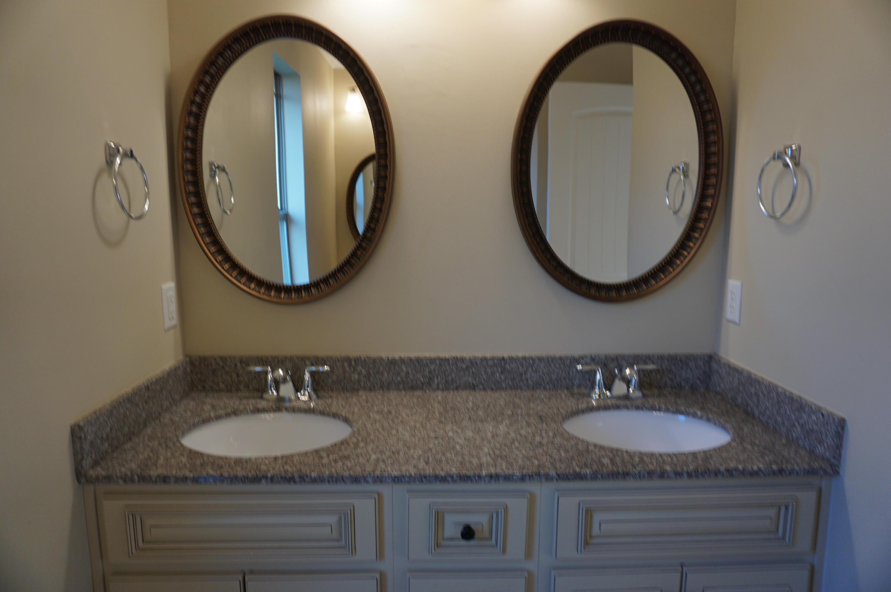 5263 Moore Loop Crestview, FL 32536 - Photo 27 of 37 a bathroom with a granite countertop double vanity sinks and a mirror