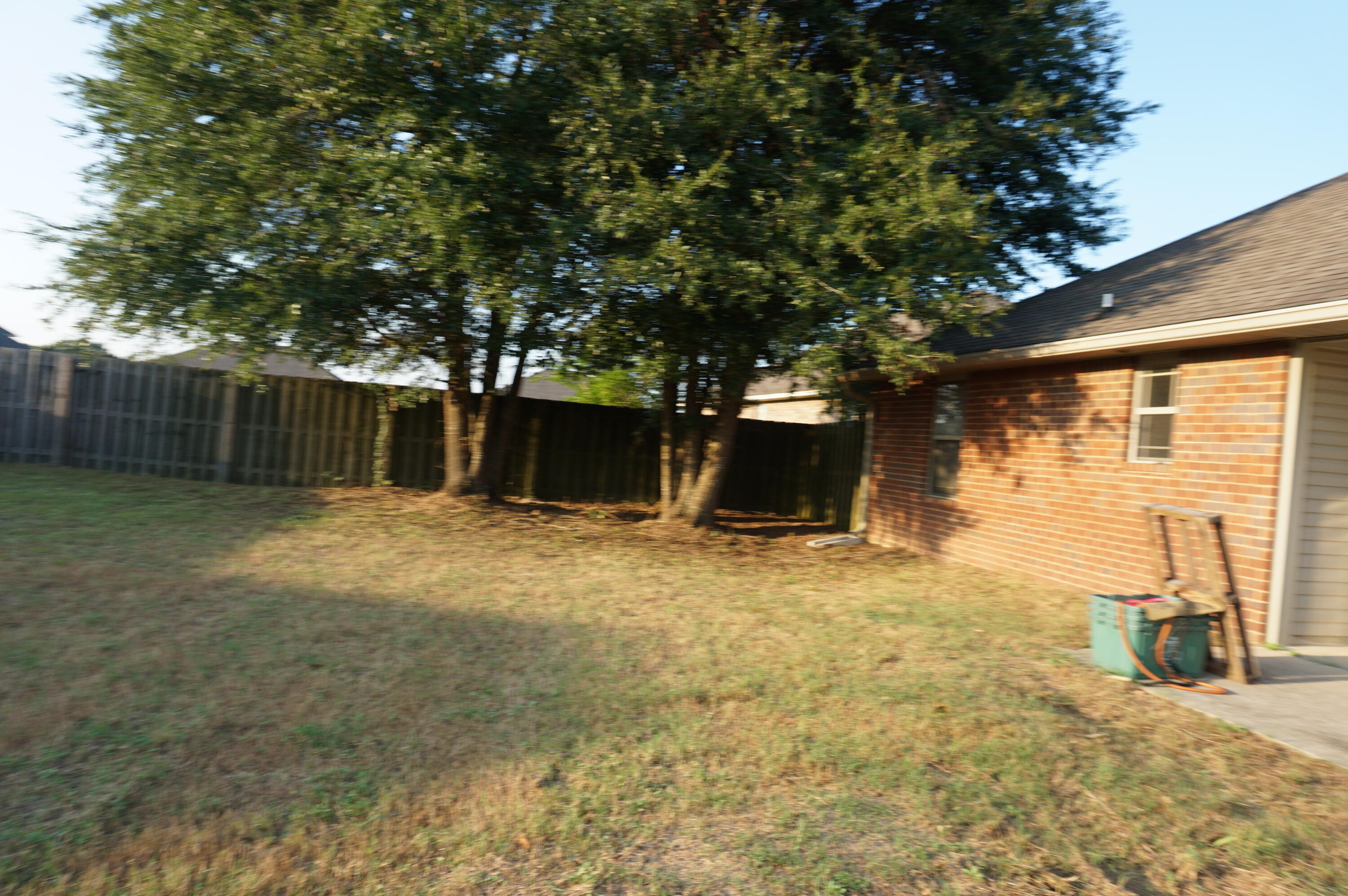5263 Moore Loop Crestview, FL 32536 - Photo 36 of 37 a view of a backyard with large tree and wooden fence