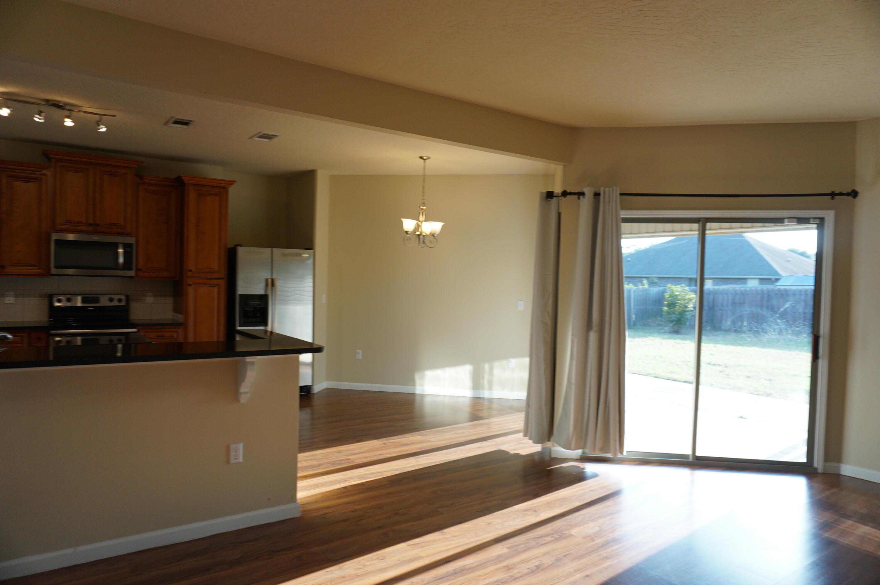5263 Moore Loop Crestview, FL 32536 - Photo 10 of 37 a view of a kitchen with wooden floor and a window