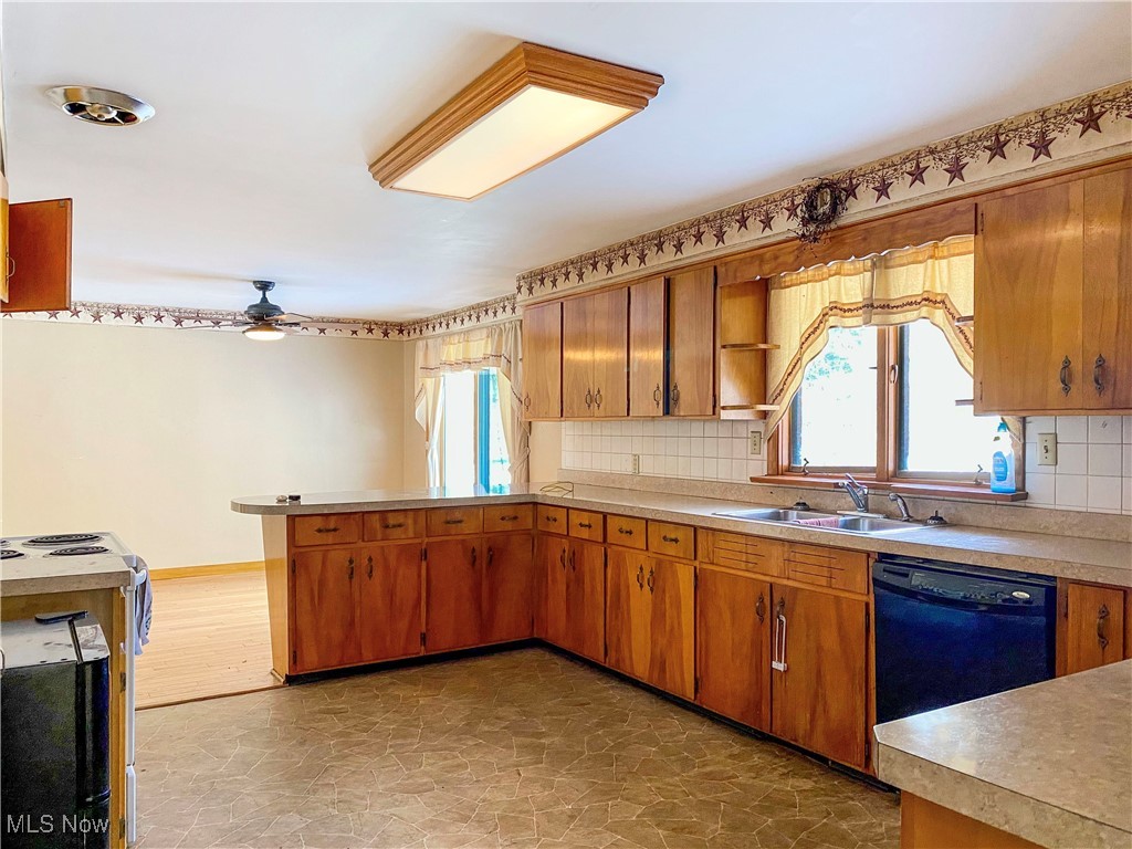 1034 Straub Road West Mansfield, OH 44904 - Photo 7 of 27 Kitchen with ceiling fan, black dishwasher, backsplash, and sink