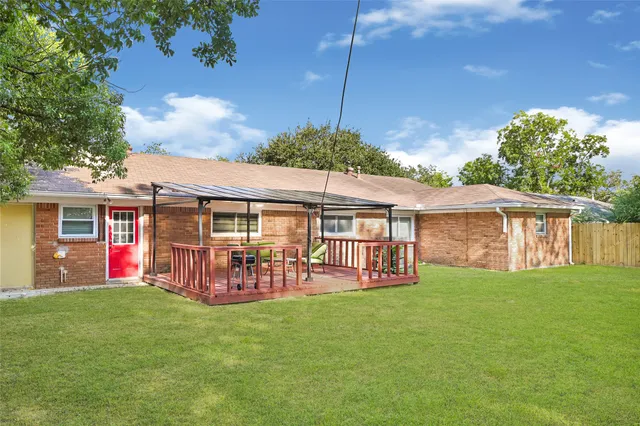 a view of a house with a yard and sitting area
