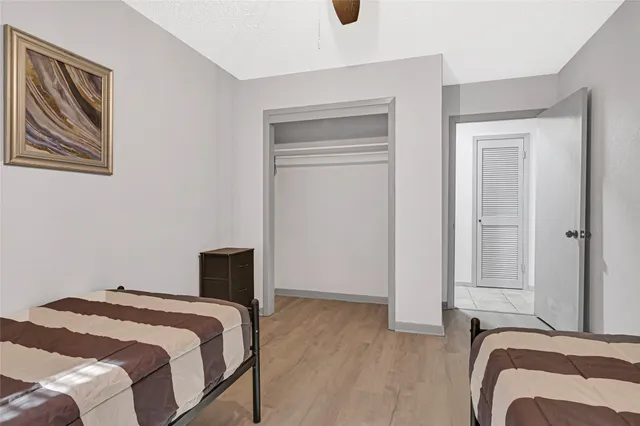 a bedroom with a bed and wooden floor