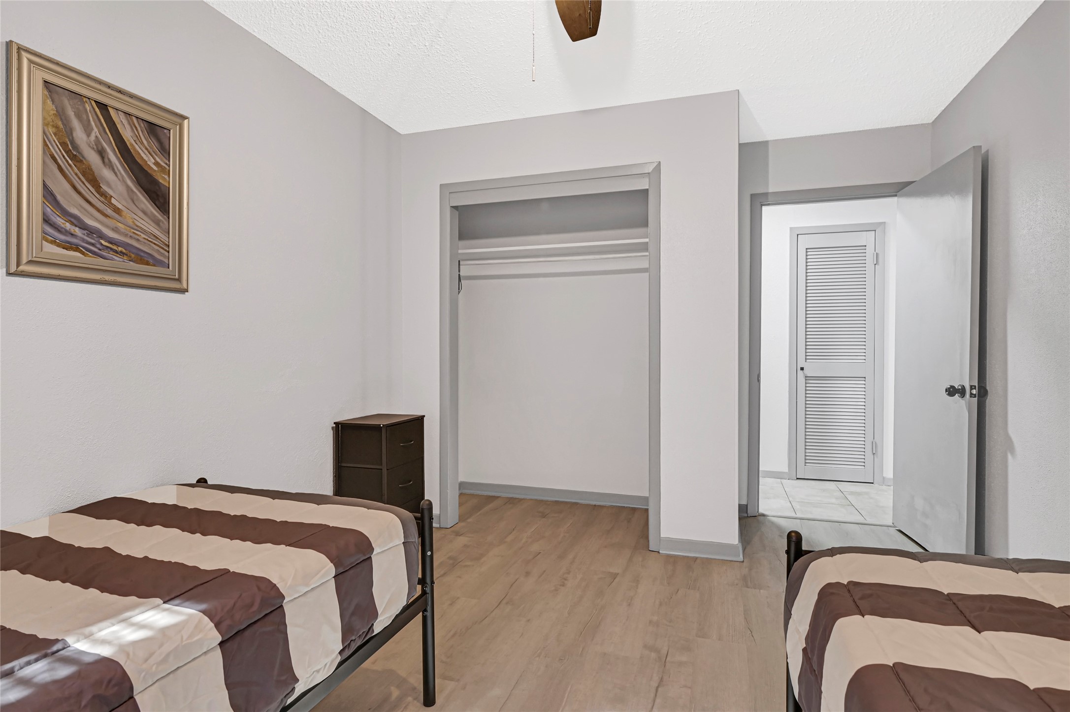 1806 Clayton Drive Baytown, TX 77520 - Photo 11 of 40 a bedroom with a bed and wooden floor